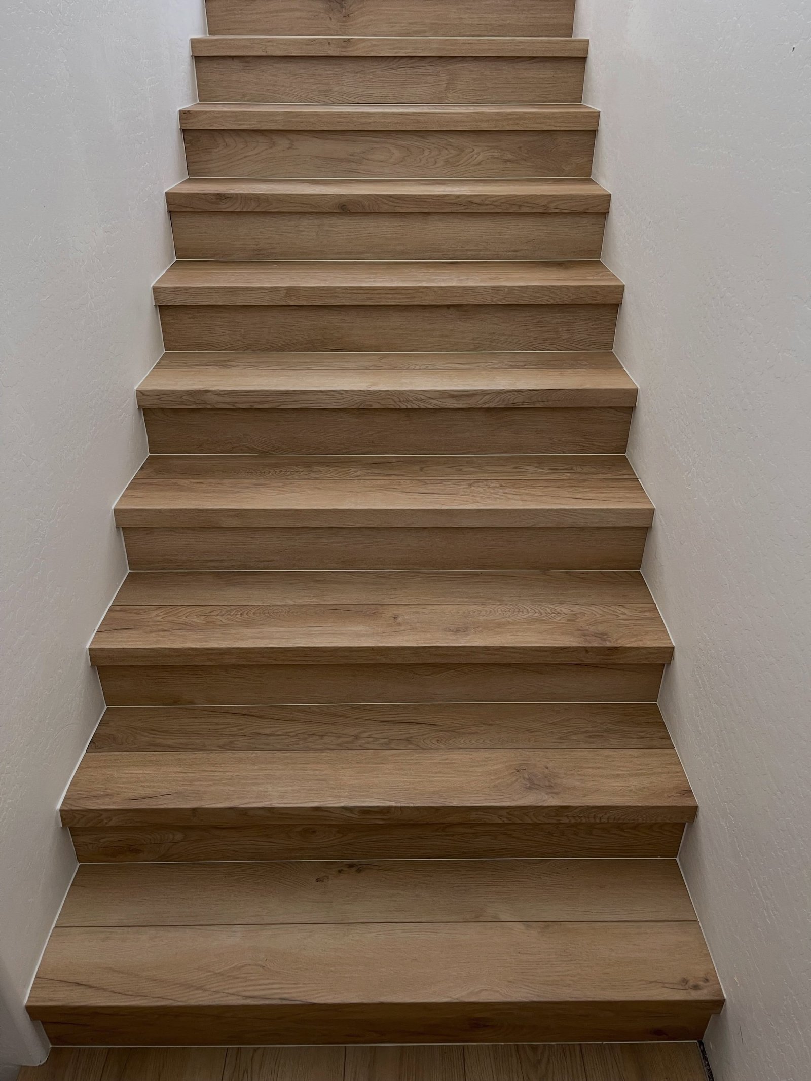 Wood-look tile staircase installed by Desert State Flooring & Design